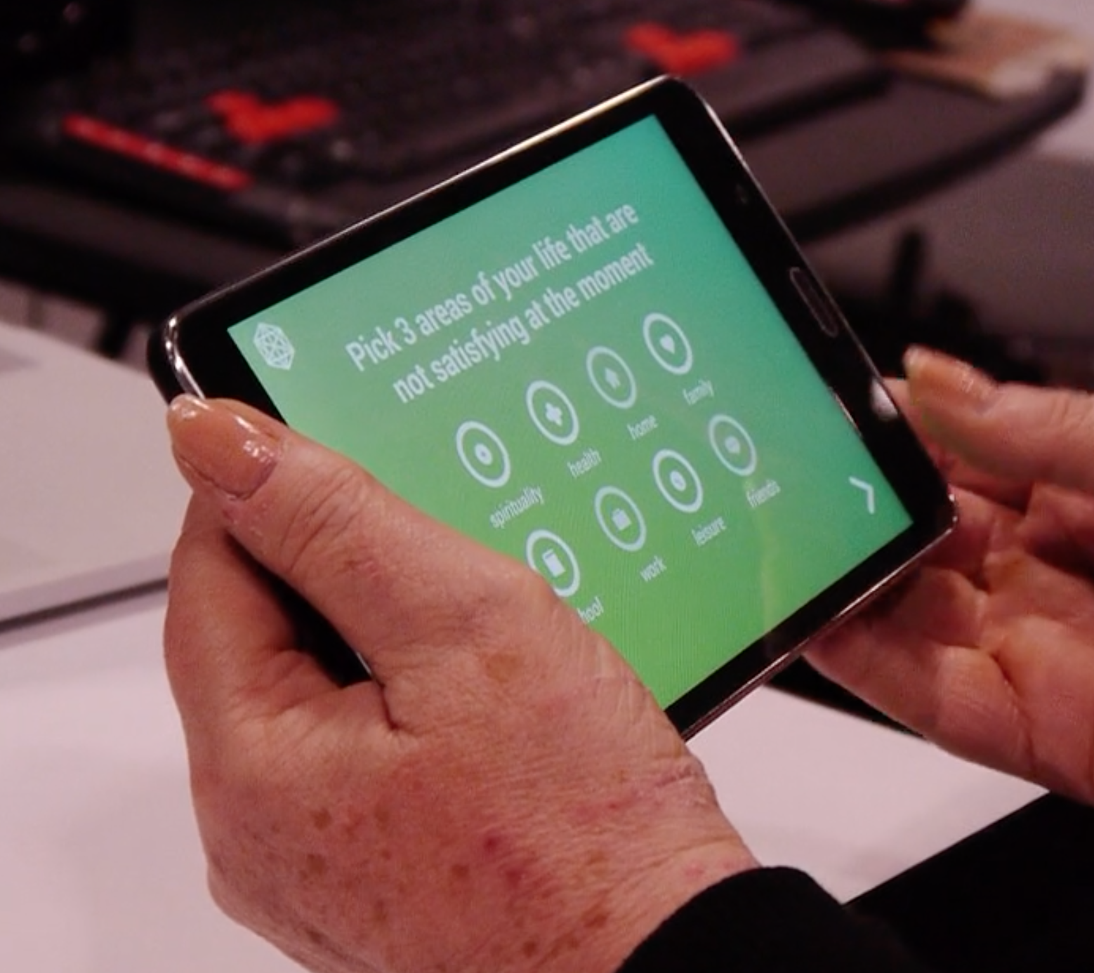 Image of a hands holding an ipad with the ACT App on screen